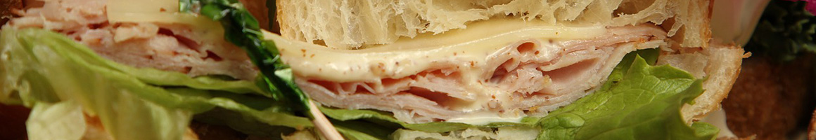 Eating Deli Sandwich at Wall Street Deli restaurant in Birmingham, AL.